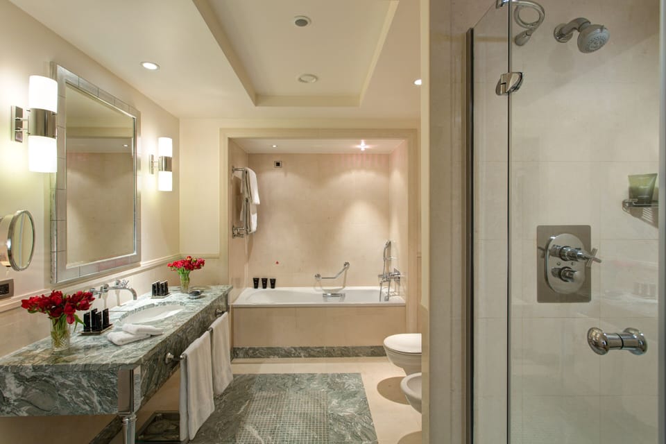 Separate tub and shower, rainfall showerhead, designer toiletries