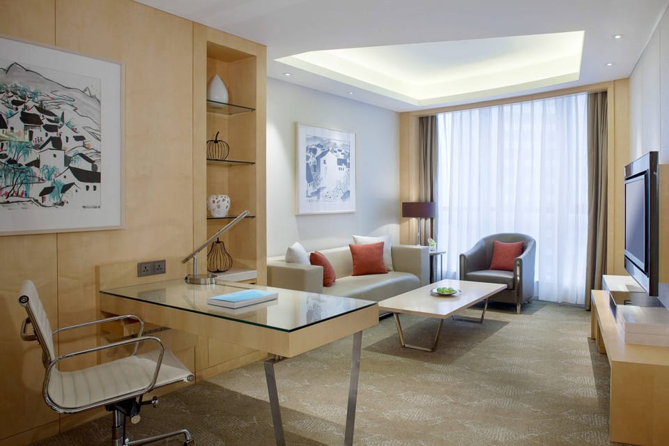 Deluxe Suite, 1 King Bed | Living area | 32-inch LCD TV with cable channels, TV, iPod dock