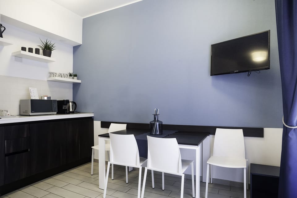 Comfort Quadruple Room, Balcony | Living area | Flat-screen TV