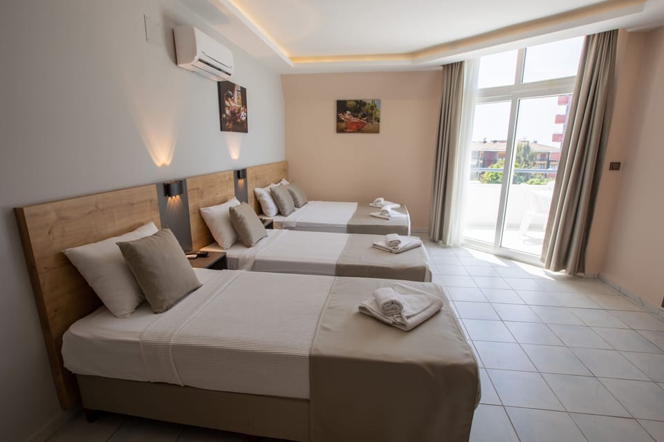 Standard Triple Room, Multiple Beds, Mountain View | Minibar, soundproofing