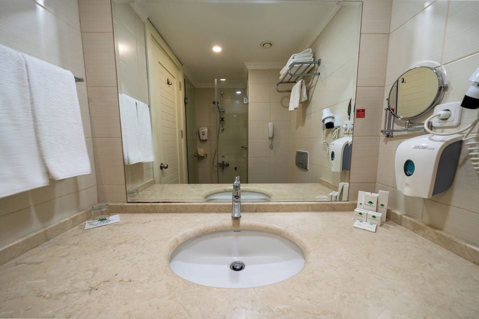 Shower, hair dryer, slippers, towels