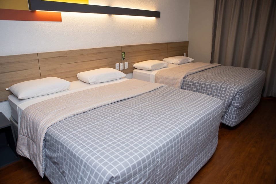 Standard Twin Room, 2 Double Beds | Minibar, in-room safe, desk, blackout drapes