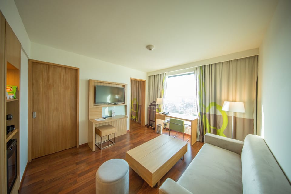 Executive Suite, 1 King Bed, Bathtub (Separate Living Room) | Living room | 32-inch LED TV with cable channels, TV, table tennis