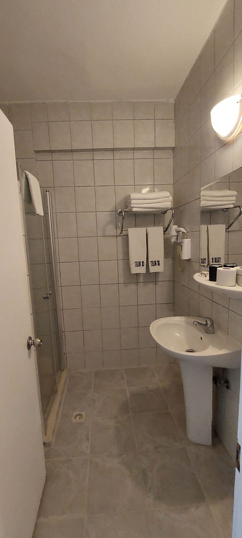 Shower, hair dryer, slippers, towels