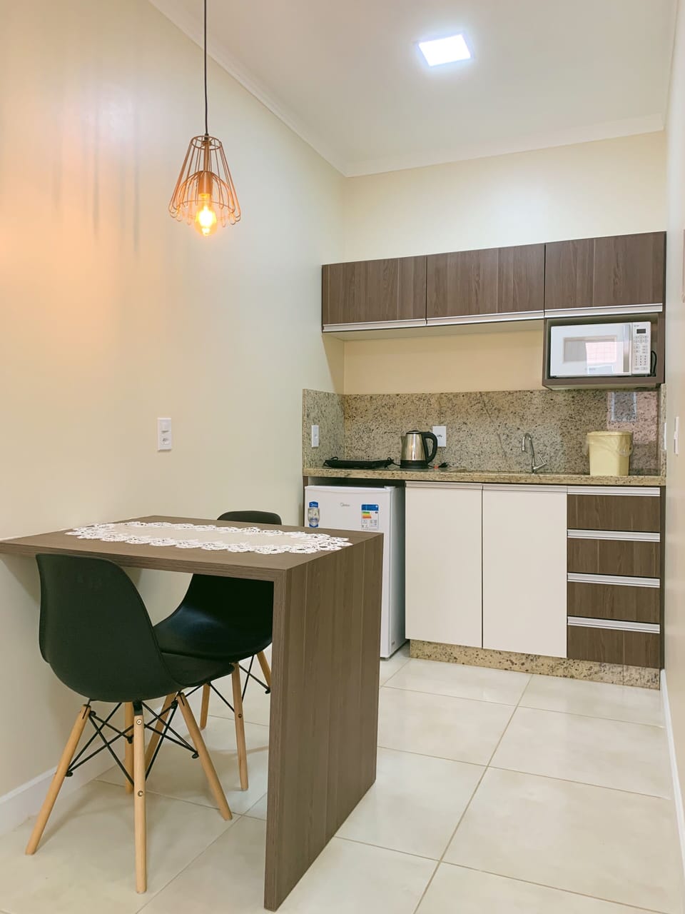 Basic Suite, 1 Double Bed | Private kitchen | Microwave, toaster, cookware/dishes/utensils, dining tables