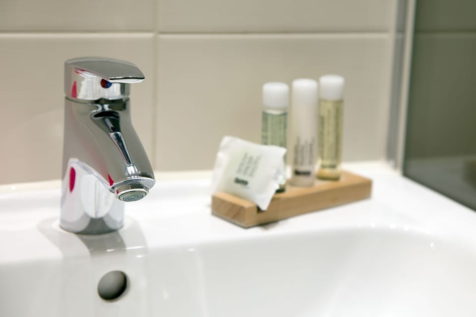 Shower, hair dryer, towels, toilet paper