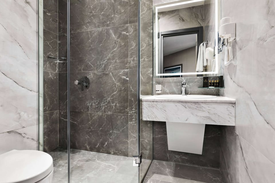 Premium Room, Multiple Beds, Non Smoking (Chamber, No Balcony) | Bathroom | Shower, free toiletries, hair dryer, bathrobes