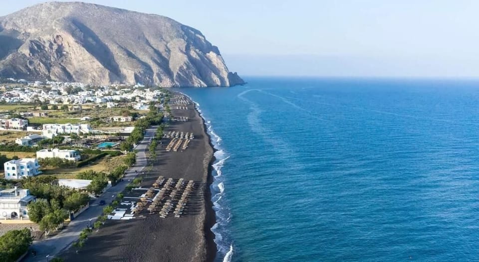 On the beach, black sand, beach towels