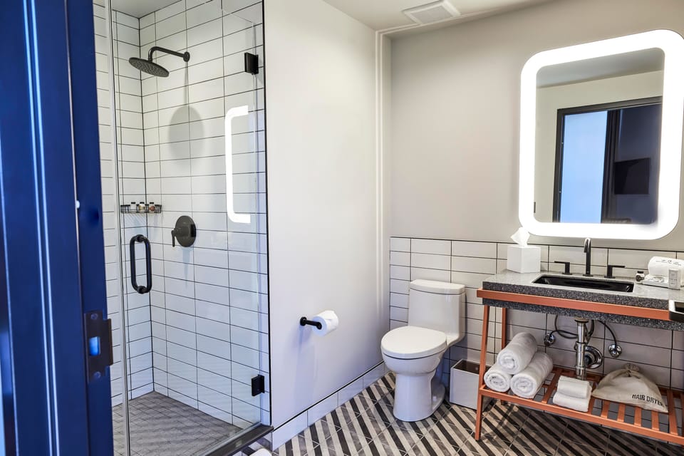 Shower, rainfall showerhead, designer toiletries, hair dryer