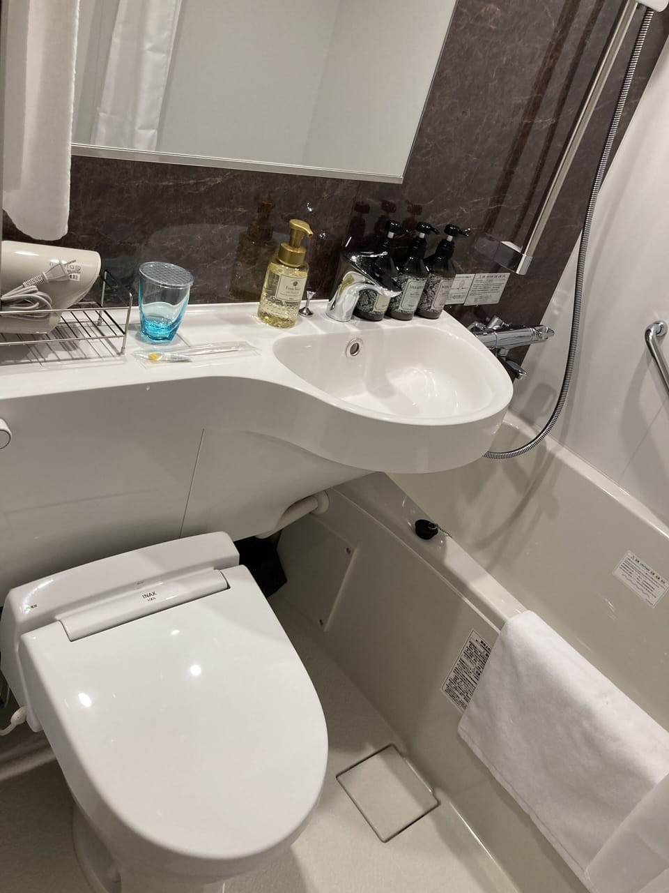 Combined shower/tub, hair dryer, slippers, bidet