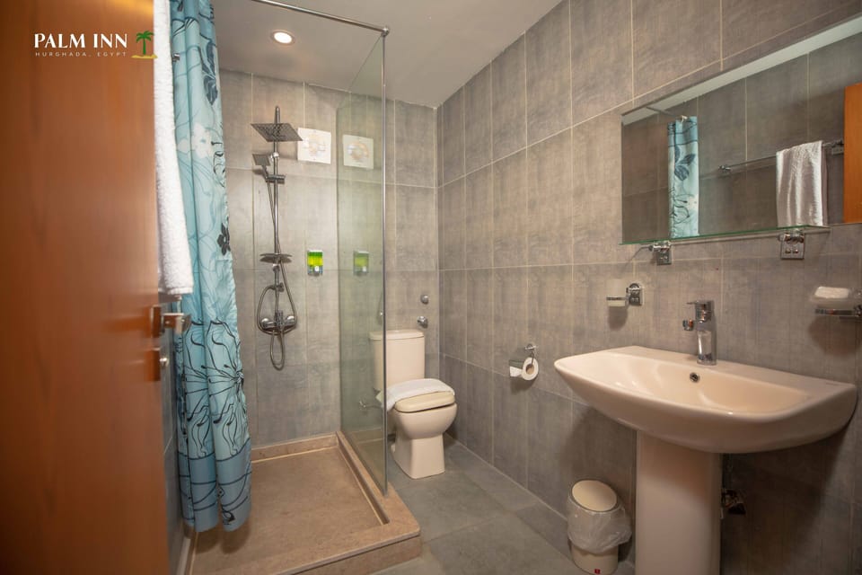 Shower, rainfall showerhead, hair dryer, towels