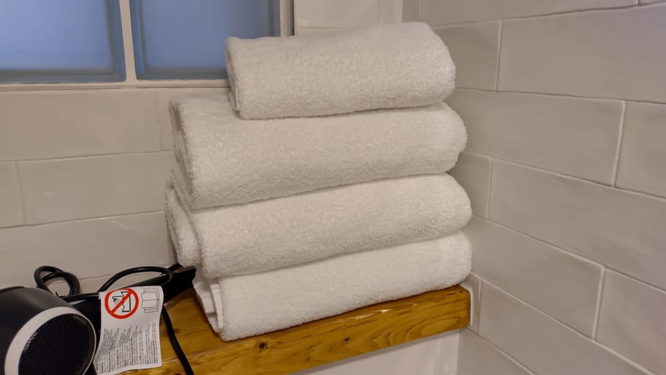 Duplex Studio | Bathroom | Hair dryer, towels, soap, toilet paper