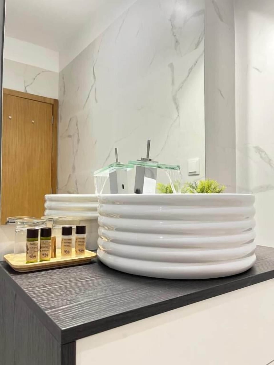 Deluxe Room | Bathroom | Designer toiletries, hair dryer, slippers, towels