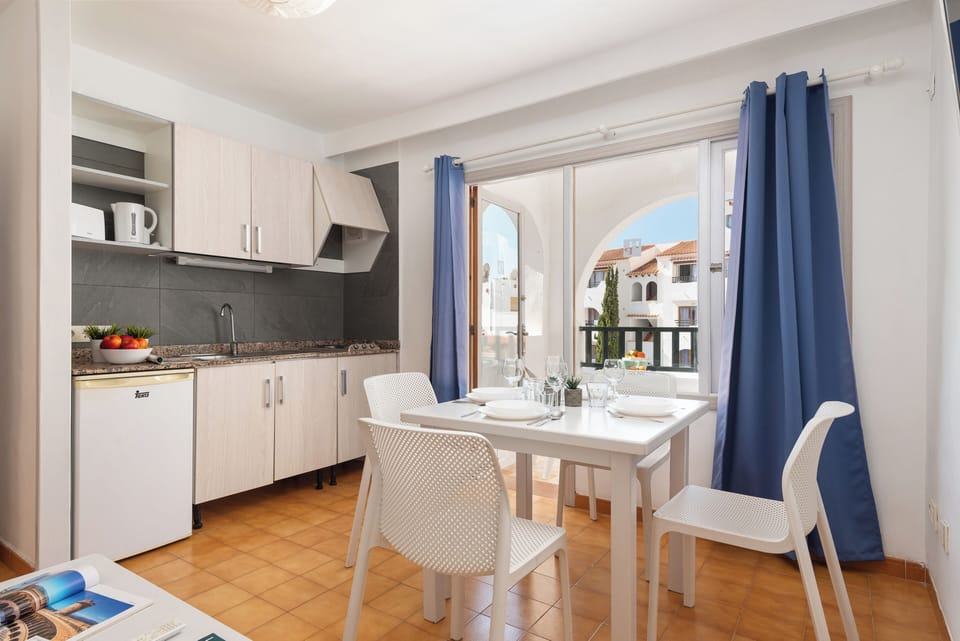 Standard Apartment, 1 Bedroom, Pool View | Private kitchen | Mini-fridge, toaster, cookware/dishes/utensils, dining table