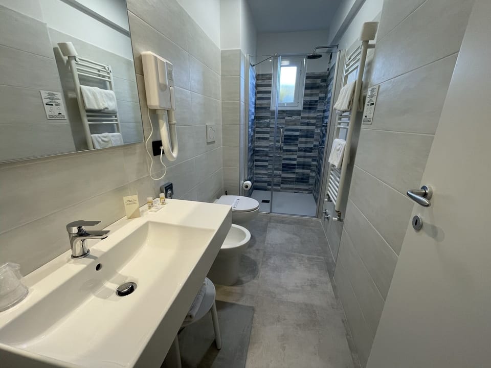 Family Room, Connecting Rooms | Bathroom | Rainfall showerhead, free toiletries, hair dryer, towels