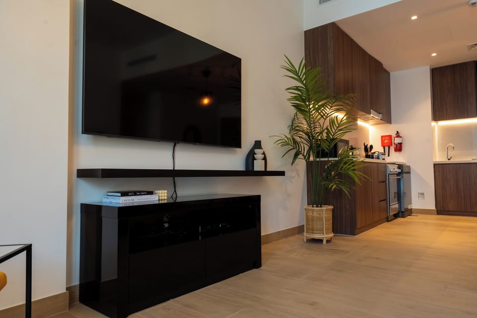 Deluxe Apartment | Living area | 55-inch Smart TV with cable channels, TV, Netflix