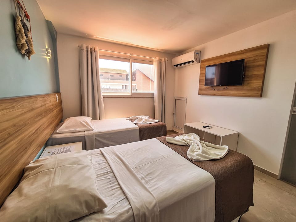Deluxe Triple Room | Desk, blackout drapes, iron/ironing board, free WiFi