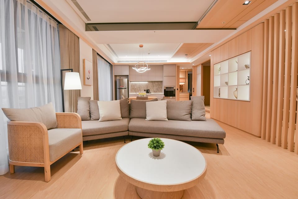 Deluxe Quadruple Room | Living area | Flat-screen TV