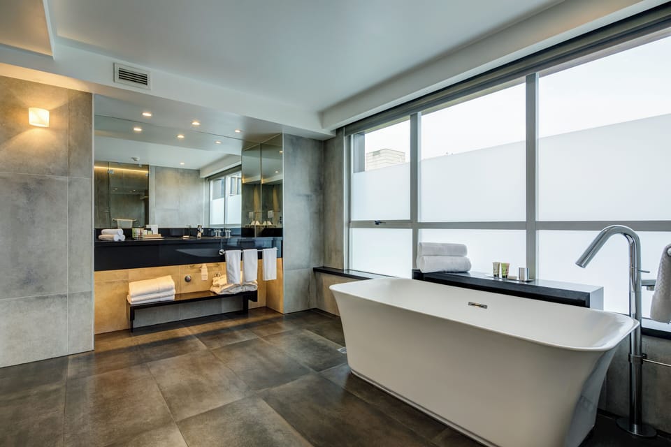 Suite, 1 King Bed | Bathroom | Hair dryer, bathrobes, towels