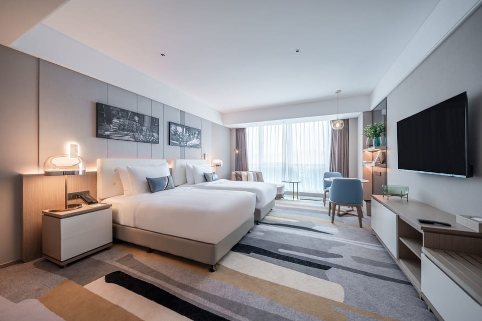 Deluxe Room, 2 Twin Beds | Down comforters, desk, laptop workspace, blackout drapes