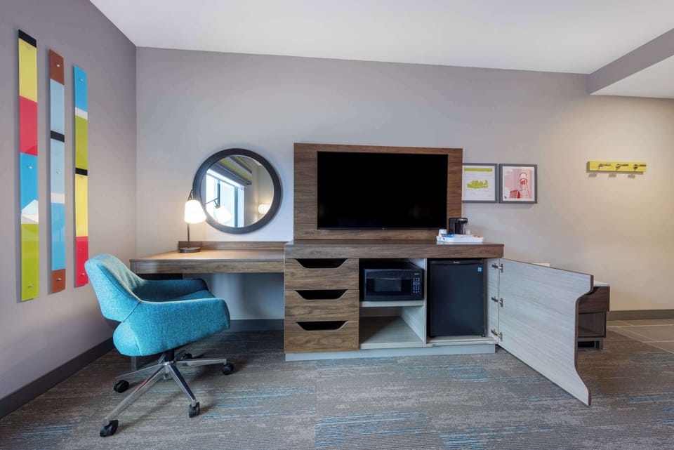 Hypo-allergenic bedding, desk, laptop workspace, blackout drapes