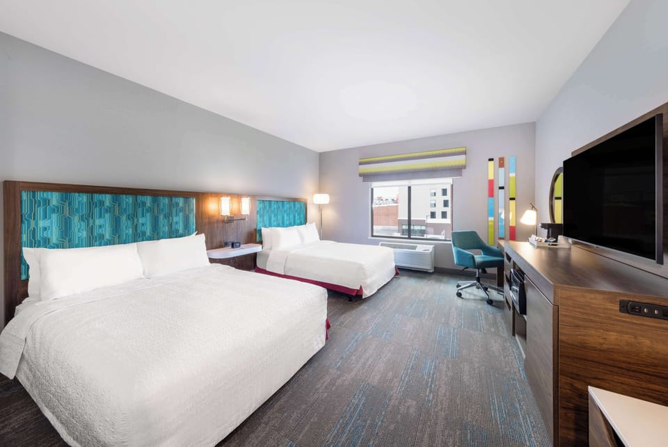 Hypo-allergenic bedding, desk, laptop workspace, blackout drapes