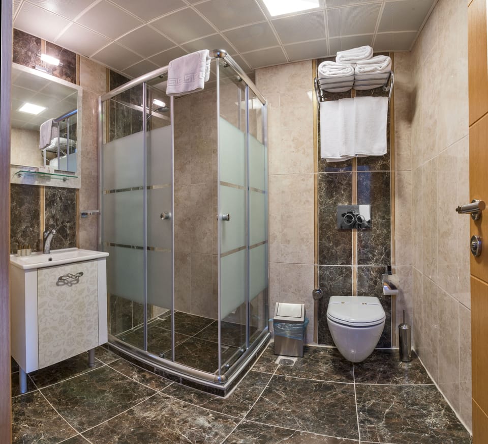 Shower, hair dryer, slippers, towels