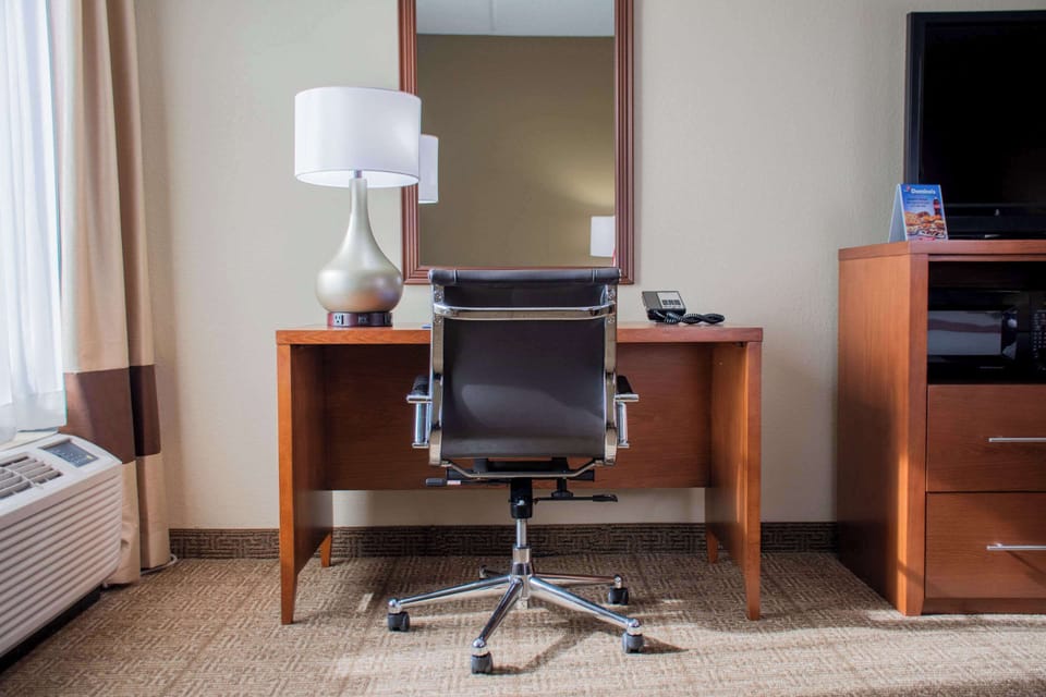 Desk, laptop workspace, blackout drapes, iron/ironing board