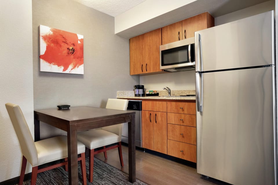 Suite, One King Bed, Non-Smoking | Private kitchen | Full-size fridge, microwave, stovetop, dishwasher