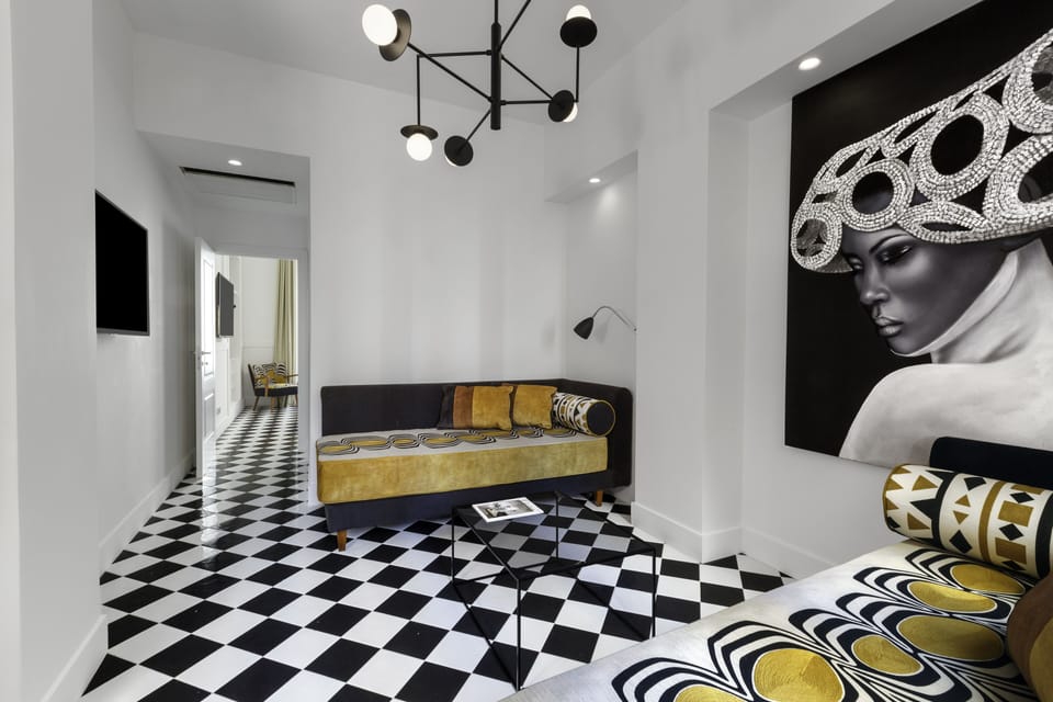 Suite, Balcony, City View | Living area | 32-inch flat-screen TV with satellite channels