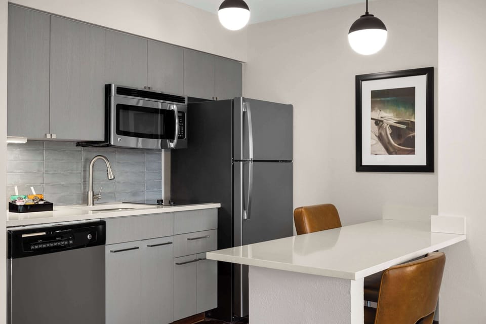 Fridge, microwave, coffee/tea maker, cookware/dishes/utensils