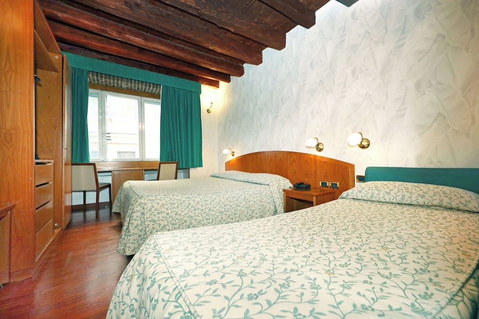 Triple Room | Minibar, in-room safe, desk, soundproofing