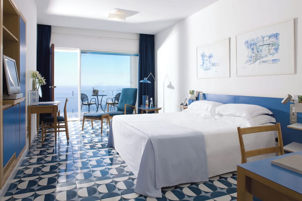 Deluxe Triple Room, Sea View | Hypo-allergenic bedding, minibar, in-room safe, desk