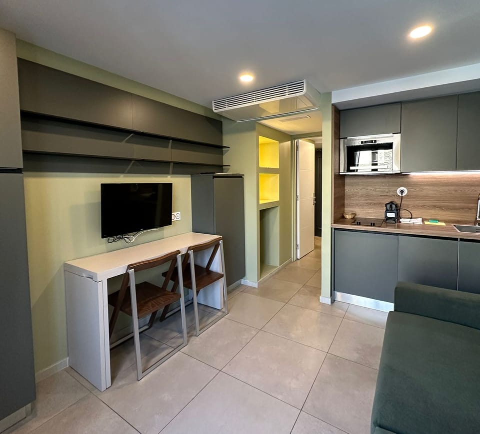 Standard Apartment | Living area | 22-inch flat-screen TV with digital channels, TV
