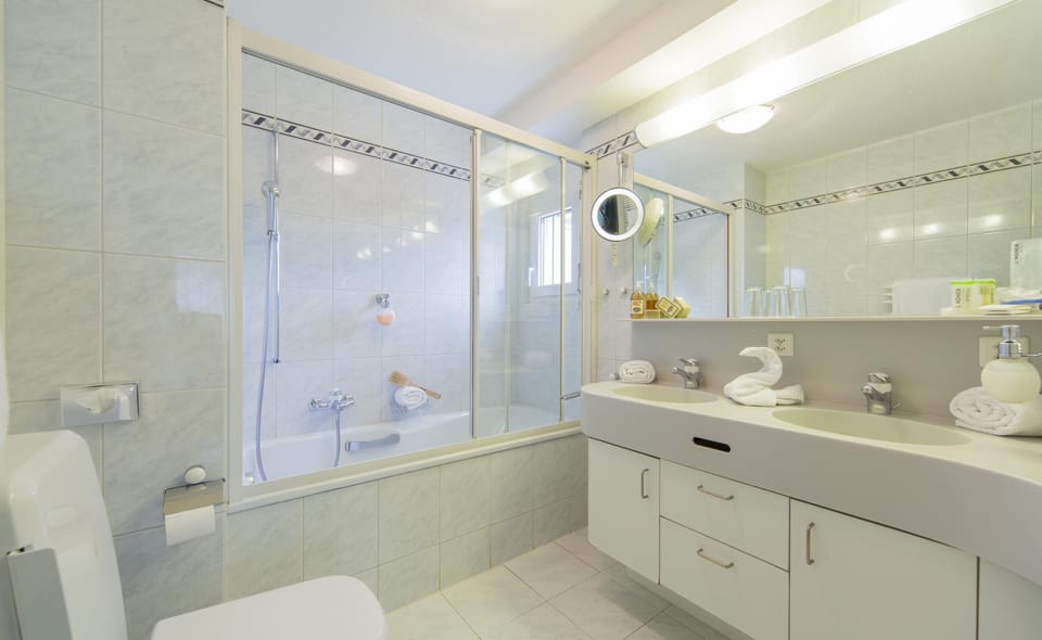 Combined shower/tub, designer toiletries, hair dryer, bathrobes