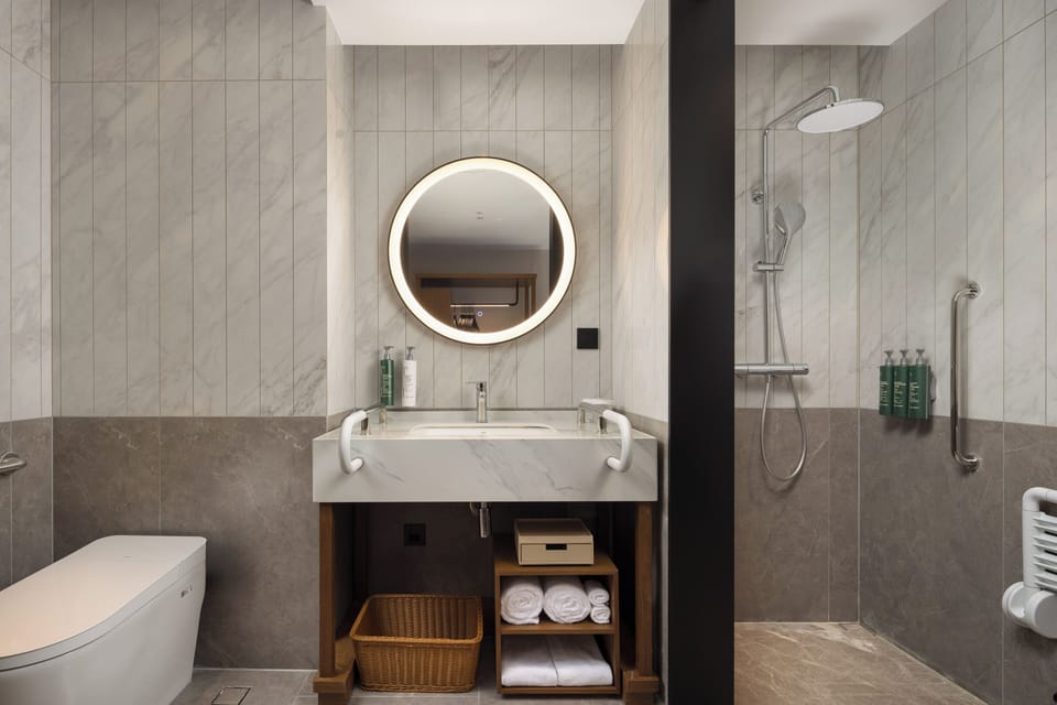 King Accessible Room | Bathroom | Shower, rainfall showerhead, hair dryer, slippers