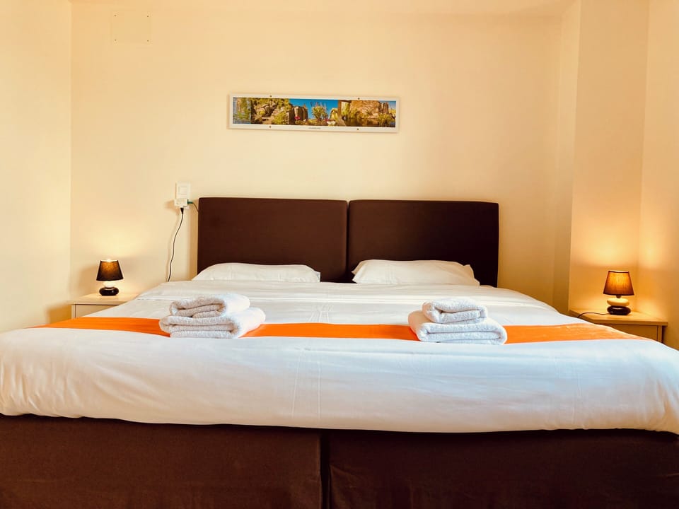 Premium bedding, desk, laptop workspace, iron/ironing board