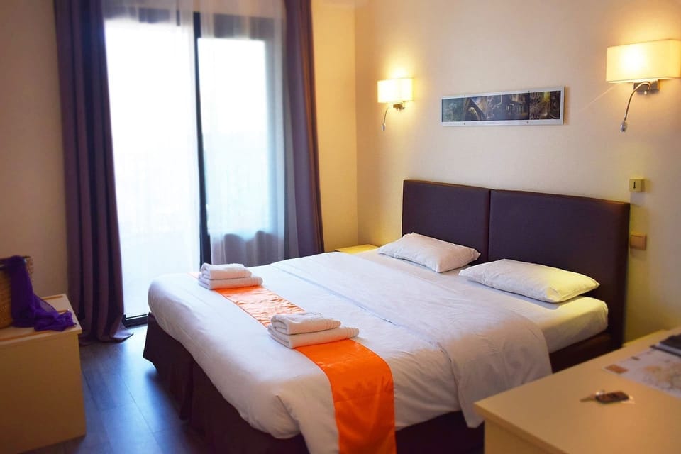 Premium bedding, desk, laptop workspace, iron/ironing board