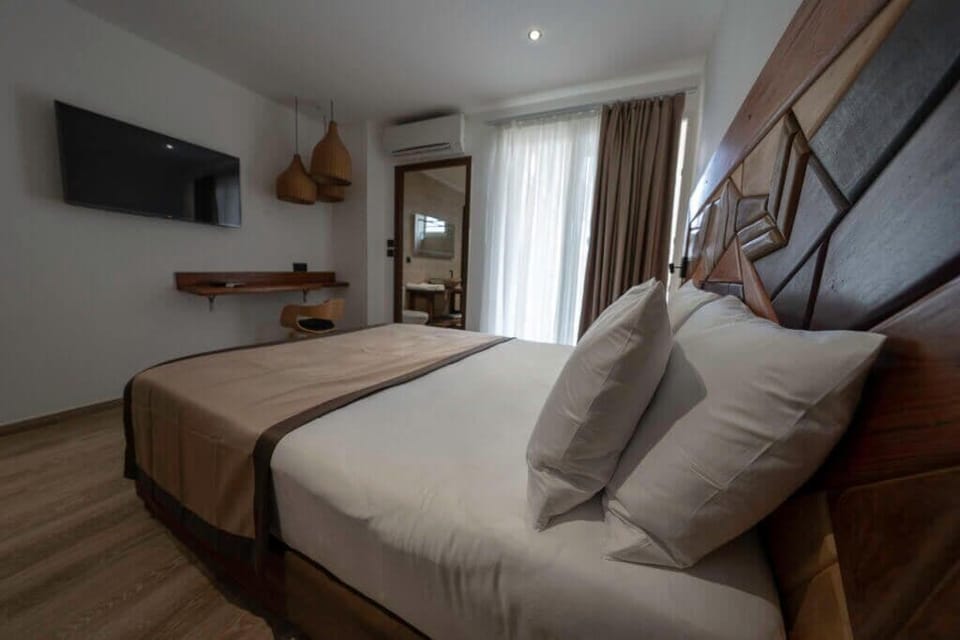 Standard Room | Minibar, in-room safe, laptop workspace, iron/ironing board