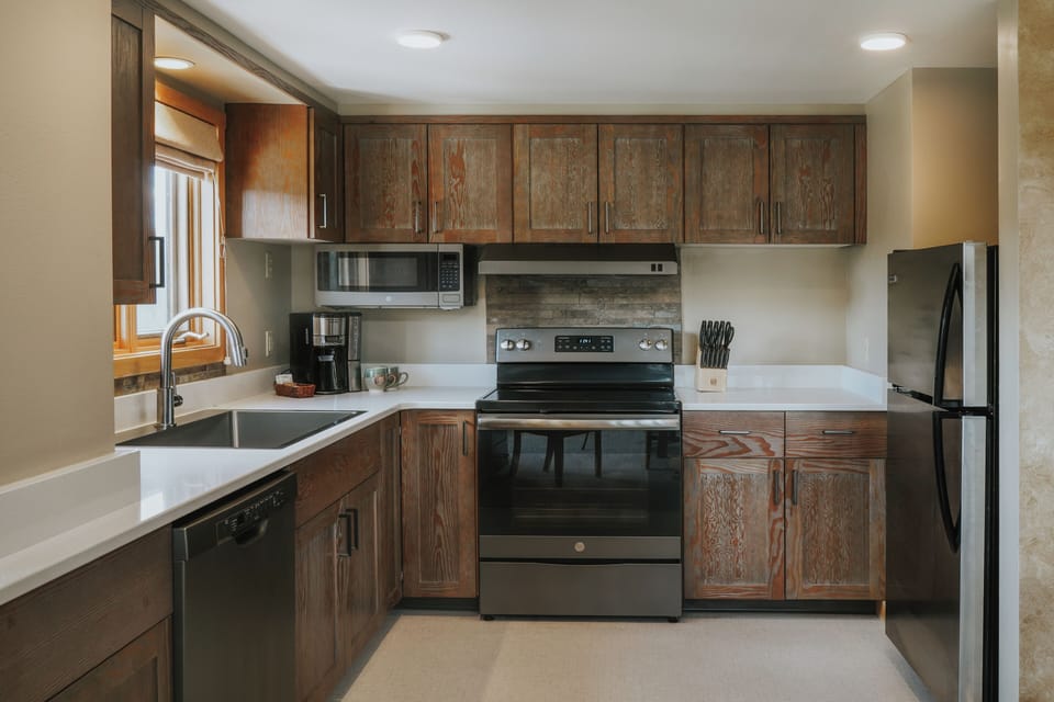 Deluxe Condo | Private kitchen | Full-size fridge, microwave, stovetop, dishwasher