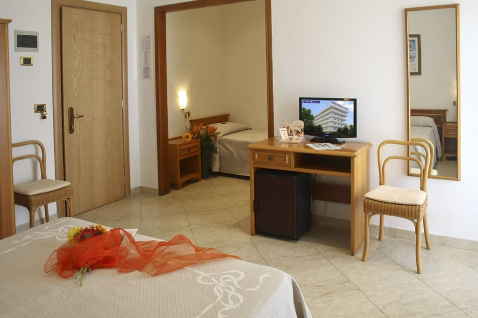 Standard Quadruple Room | Minibar, in-room safe, desk, bed sheets