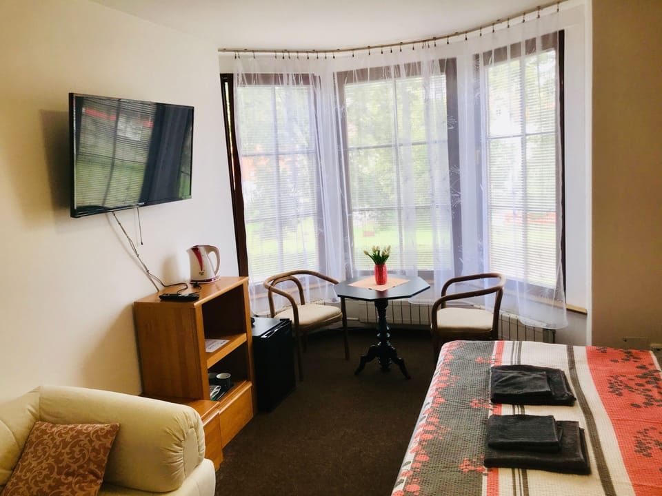 Standard Triple Room (4) | Living area | 90-cm flat-screen TV with satellite channels