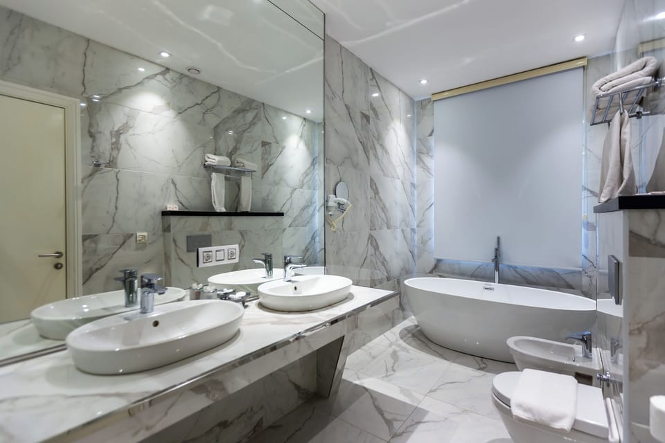 Shower, designer toiletries, hair dryer, bathrobes