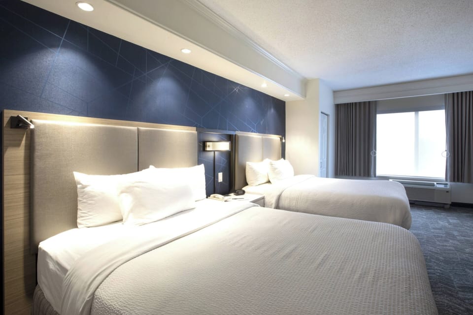 Down comforters, pillowtop beds, in-room safe, desk