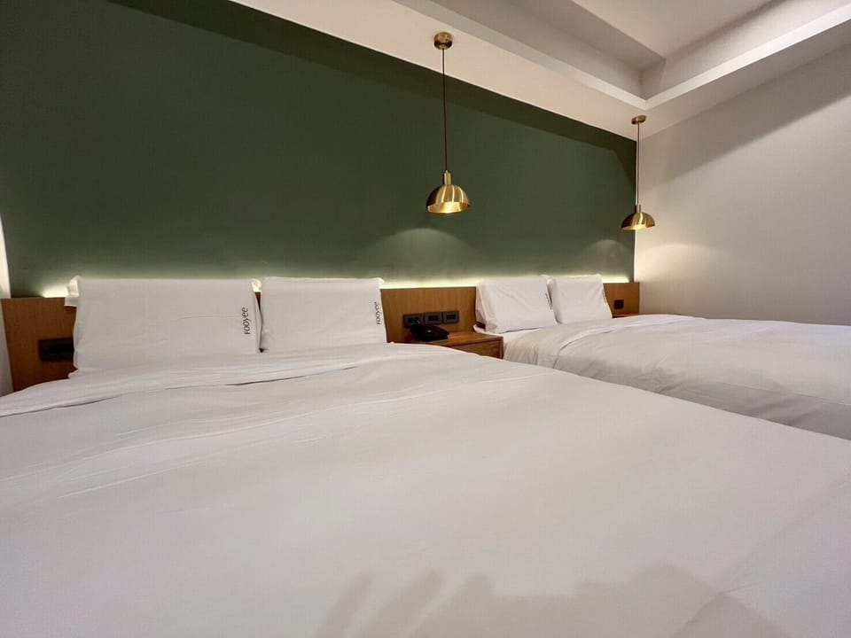 Family Quadruple Room, 2 Queen Beds | Down comforters, free minibar, desk, blackout drapes