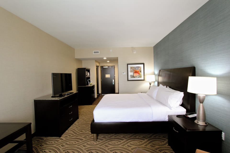 Premium bedding, desk, laptop workspace, blackout drapes