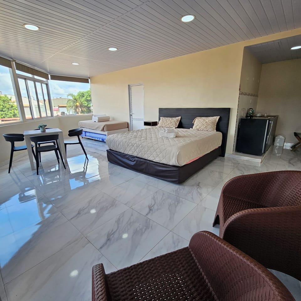 Deluxe Quadruple Room | Minibar, in-room safe, desk, laptop workspace