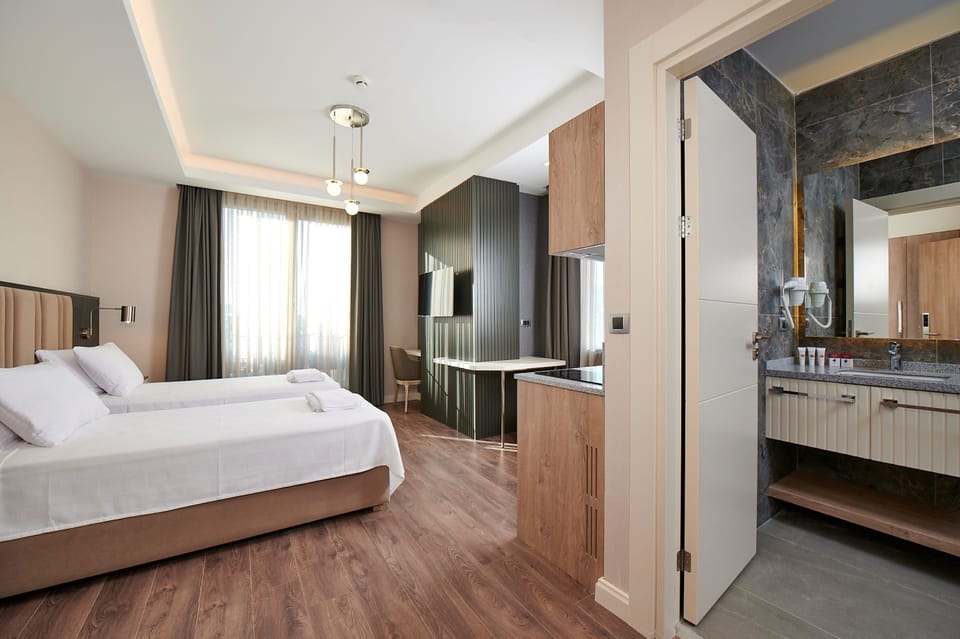 Deluxe Corner With Kitchen Room | Minibar, desk, laptop workspace, soundproofing