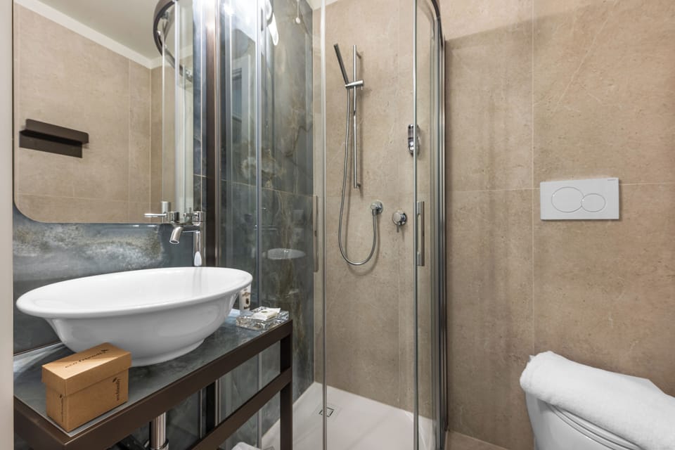 Single Room | Bathroom | Shower, hair dryer, slippers, towels