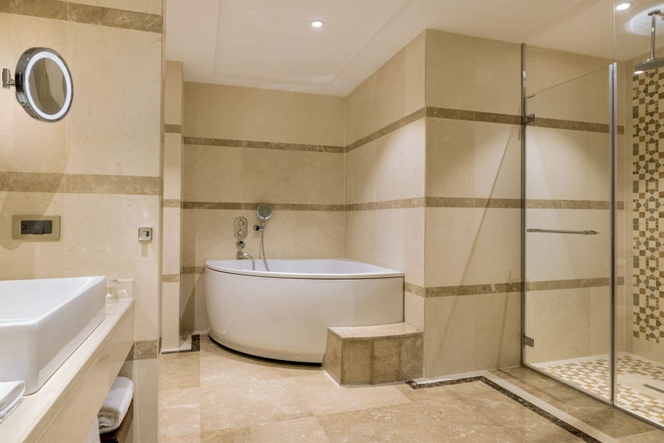 Separate tub and shower, rainfall showerhead, free toiletries